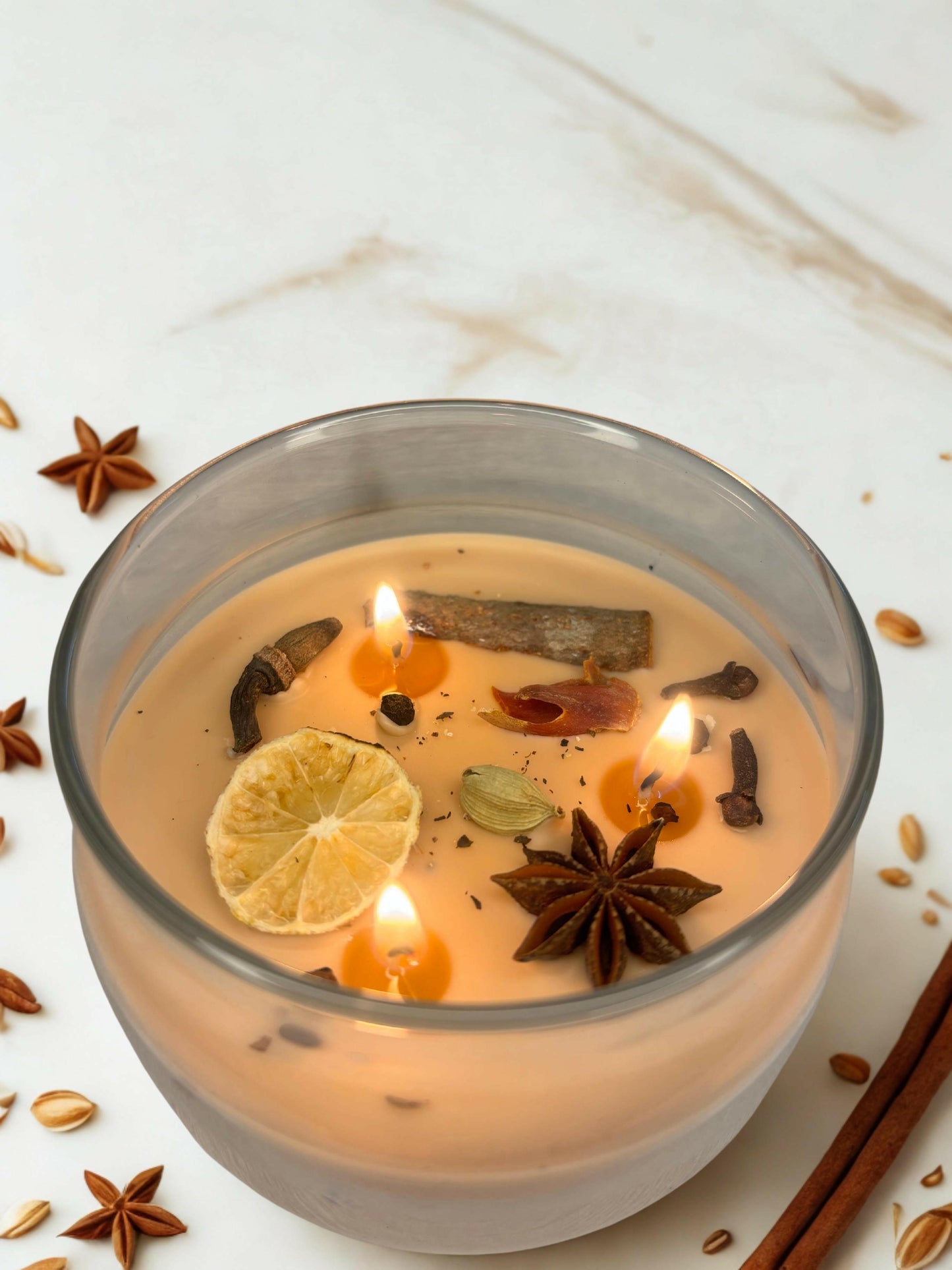 Lit cinnamon candle glowing warmly in cozy setting